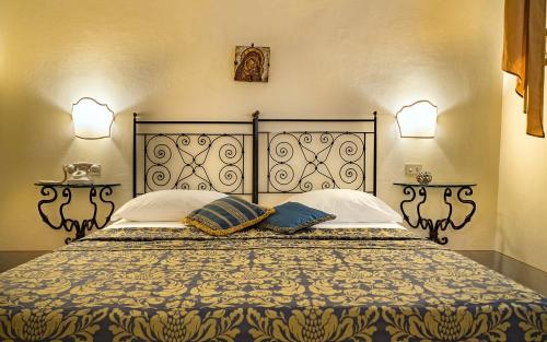 a bedroom with a large bed with two pillows at B&B Piccolo Hotel in Cortona