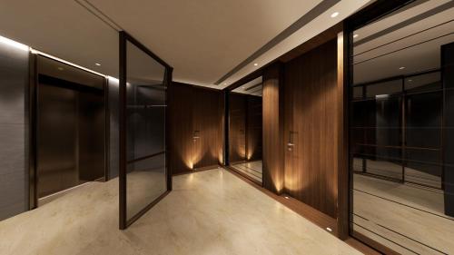 a hallway with wooden walls and glass doors at Modern Heights in Juffair