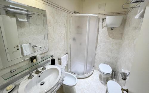 a bathroom with a sink and a shower and a toilet at B&B Piccolo Hotel in Cortona