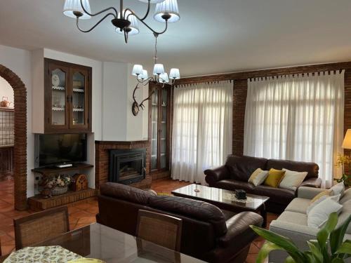 a living room with a couch and a fireplace at Casa Rural Mijarra **** in Herrera del Duque