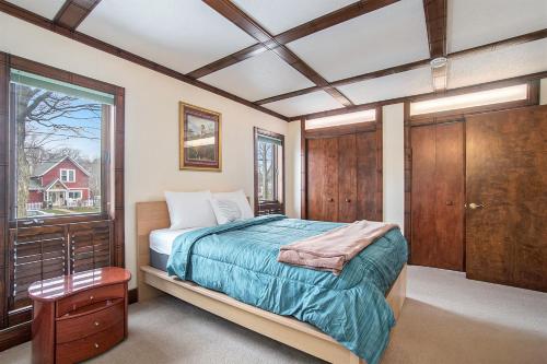 a bedroom with a bed and a window at The Sugar Maple Home in South Haven