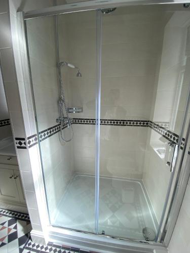a shower with a glass door in a bathroom at Chester House Guest House in Chester