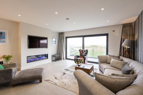 a living room with two couches and a tv at Curran Gate Luxury Serviced Apartments, Portrush in Portrush