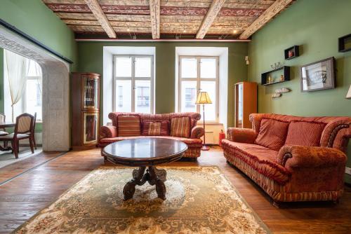 a living room with two couches and a coffee table at Old Town - Dunkri Apartment in Tallinn