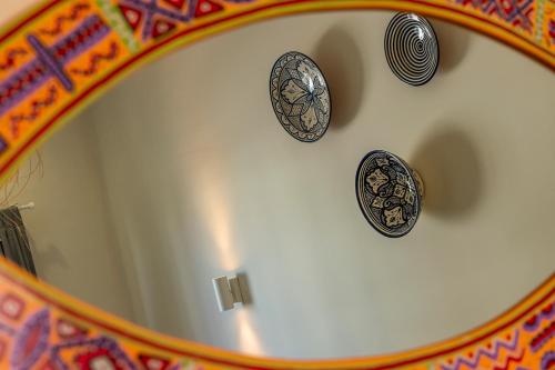 a bath tub with four plates on the wall at Kite House Dakhla in Dakhla