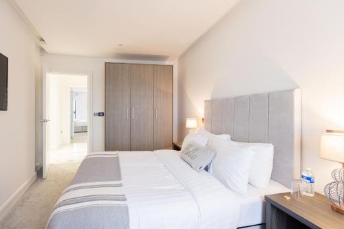 a bedroom with a large white bed with white pillows at Curran Gate Luxury Serviced Apartments, Portrush in Portrush