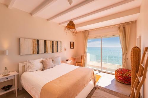 a bedroom with a bed and a large window at Kite House Dakhla in Dakhla