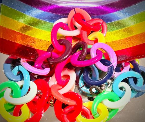 a group of colorful chainmailles hanging from a rainbow at Le Yellow - Hôtel Particulier XIXème in Montpellier