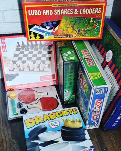 a pile of games and toys on a table at Atlantic Coast Lodge in Spanish Point