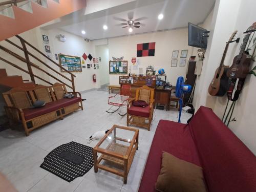 a living room with a couch and chairs and a table at Moicca Hostel in Iquitos