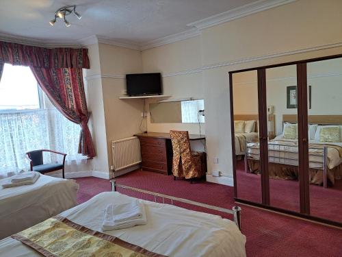 a hotel room with two beds and a mirror at Diamond House in Rugby
