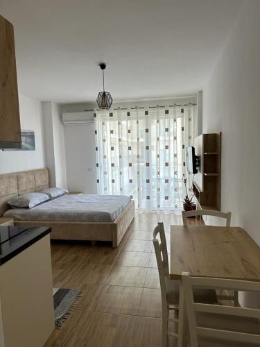 a living room with a bed and a table at Sea View Mario's Studio in Sakës