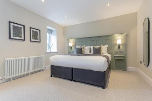 a bedroom with a large bed in a room at The Old Mill Inn in Dearham
