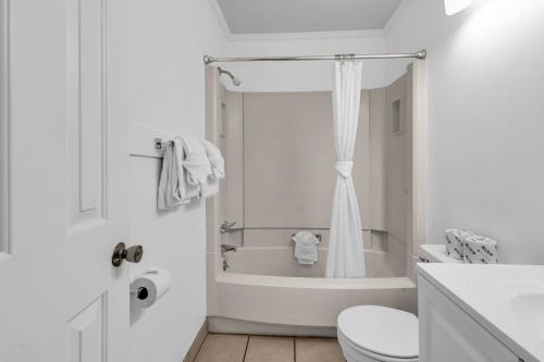 a white bathroom with a tub and a toilet at Walking distance to the beach Ocean Forest Villas in Myrtle Beach