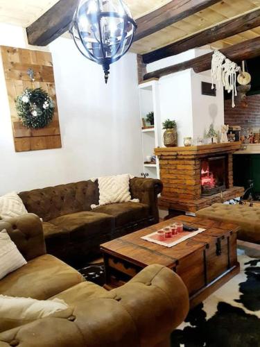 a living room with a couch and a coffee table at Chata Dagmar in Lazy pod Makytou
