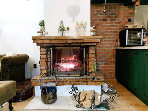 a living room with a brick fireplace in a room at Chata Dagmar in Lazy pod Makytou