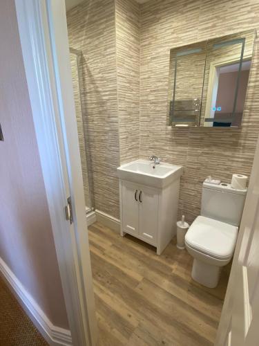 a bathroom with a toilet and a sink at Chester House Guest House in Chester