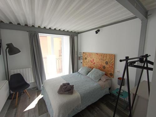 ein Schlafzimmer mit einem Bett und einem großen Fenster in der Unterkunft Estudio con encanto en Casco Antiguo de Burgos P2 in Burgos