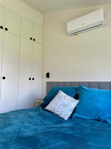 a bedroom with a bed with a blue comforter at Domki Karpatia BB in Bielsko-Biala