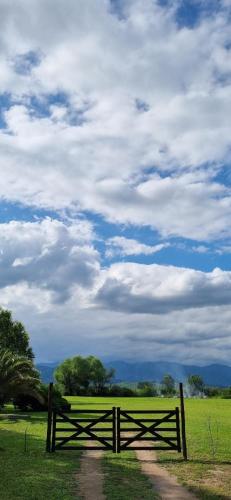 a wooden fence in the middle of a field at Posada El Prado in Salta