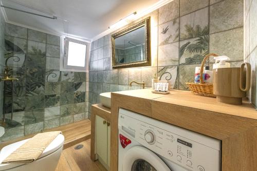 a bathroom with a washing machine and a sink at Vintage Boutique Penthouse in Piraeus