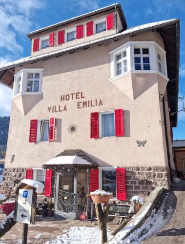 a hotel villa emilia with red shuttered windows at Hotel Villa Emilia in Ortisei