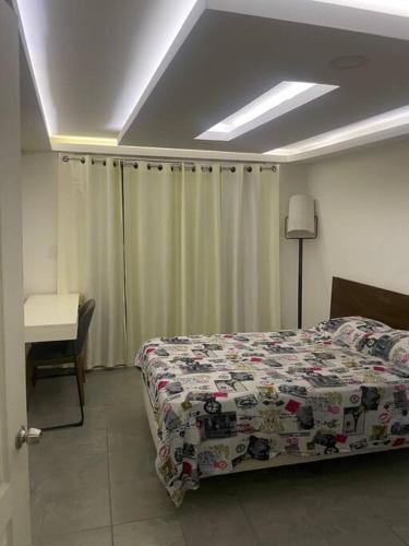 a bedroom with a bed and a table and a desk at Casa in Alpuyeca