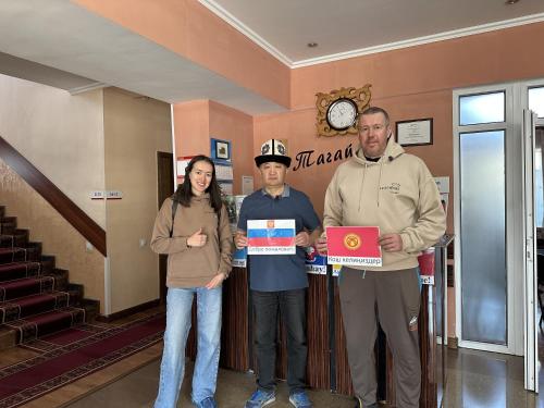 a group of people standing in a hallway holding a sign at Tagaytay Karakol Hotel in Karakol