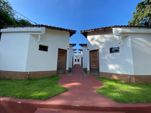 a building with two doors and a walkway at Alter Villa Suítes in Alter do Chao