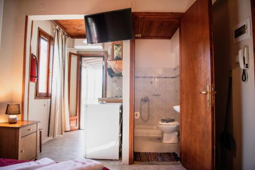 a bathroom with a shower and a toilet and a sink at Studio Sevasti in Kala Nera