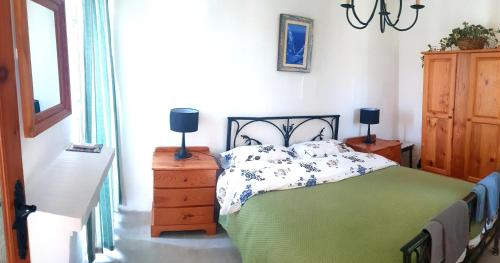 a bedroom with a bed and two lamps on dressers at B&b Seaview terrace in Għajnsielem