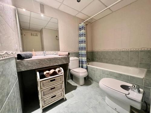 a bathroom with a sink and a toilet and a tub at Casa Pepa by Sun & Sea Homes in Moraira