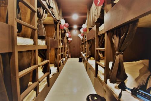 a long aisle in a room with many beds at ASRA DORMITORY For Male And Female in Mumbai