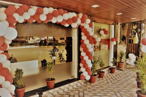 a store front with a bunch of red and white balloons at ASRA DORMITORY For Male And Female in Mumbai