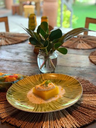 a plate with a piece of food on a table at Aldeia do Mar Sensorial Hotel in Itacaré