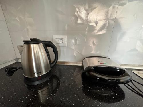 a tea kettle and a toaster on a kitchen counter at Sea View Mario's Studio in Sakës