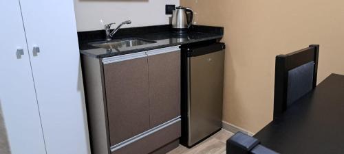 a small kitchen with a sink and a counter at La Marta in Ciudad Lujan de Cuyo