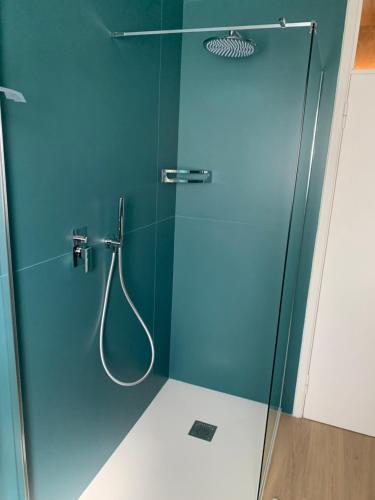 a bathroom with a shower with a glass door at Golden Ravenna- large appartment in center in Ravenna