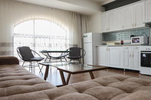 a kitchen with a couch and a table and chairs at Dream Inn H&A in Tashkent