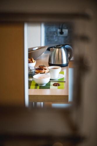 a counter with bowls of food and a tea kettle at Réva Residences and Pool in Monforte dʼAlba
