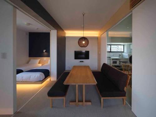 a bedroom with a bed and a table and a couch at East SQUARE Tokyo in Tokyo