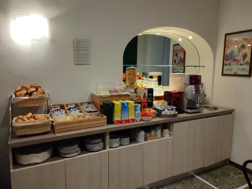 a counter in a restaurant with food on it at Hotel Tourist House in Florence