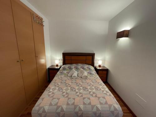 a small bedroom with a bed and two night stands at Ransol studios près des piste ski HUT08226 in Canillo