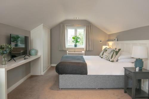 a bedroom with a large bed and a window at George Hotel, BW Signature Collection in Norwich