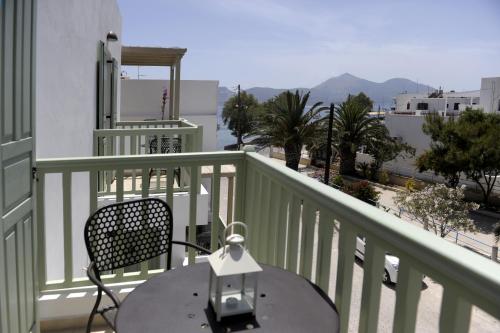 a table and chairs on a balcony with a view at Almyris in Adamas