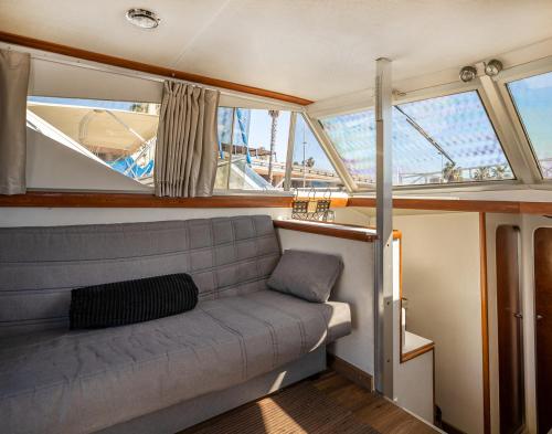 a couch sitting in the back of a boat at Spacious and charming BOAT in Port Forum in Barcelona