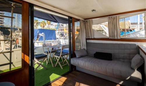 a living room with a couch and a table at Spacious and charming BOAT in Port Forum in Barcelona