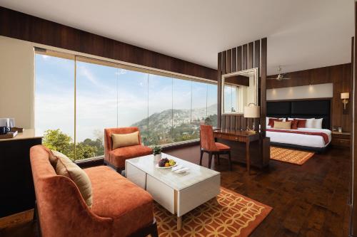 a hotel room with a bed and a living room at Fortune Resort Kalimpong- Member ITC's hotel group in Kalimpong
