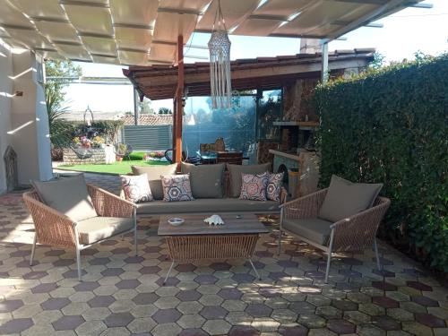 a patio with a couch and chairs and a table at Luxury Villas Chrysa Private Pool & Spa in Nafplio