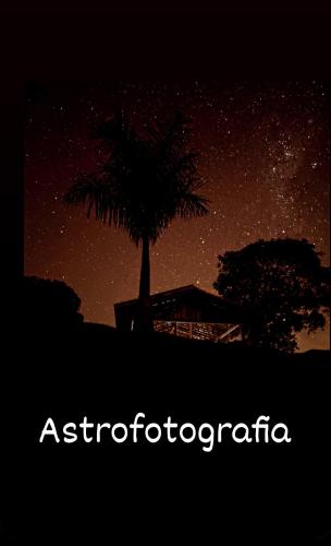 a starry night with a palm tree in the background at Pousada Mirante dos Ipês - Capitólio - MG in Capitólio